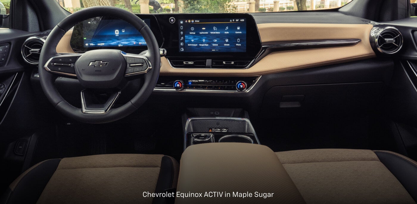 Front-row interior cockpit view of a Chevrolet Equinox ACTIV in Maple Sugar displaying panoramic screens.