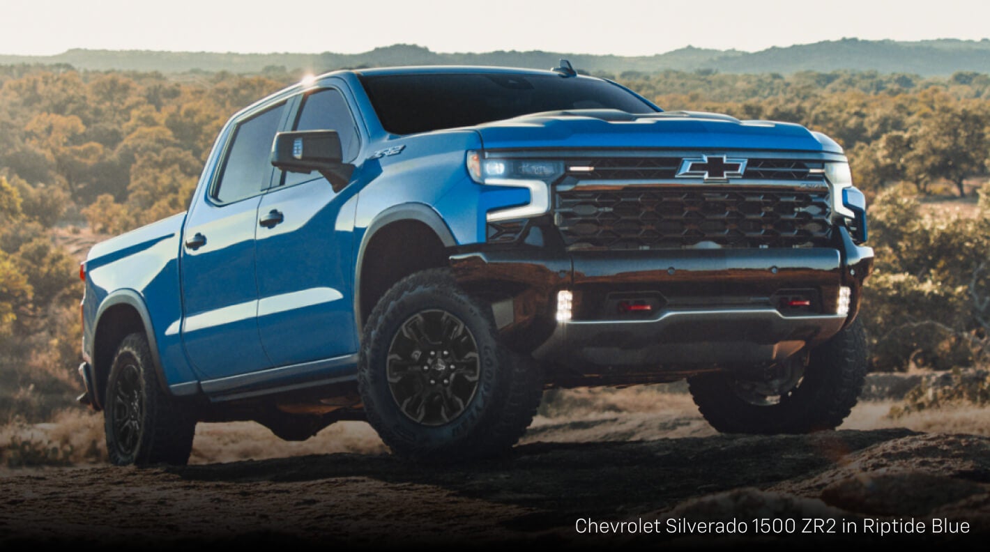 Chevrolet Silverado 1500 ZR2 in Riptide Blue, driving on rocky terrain