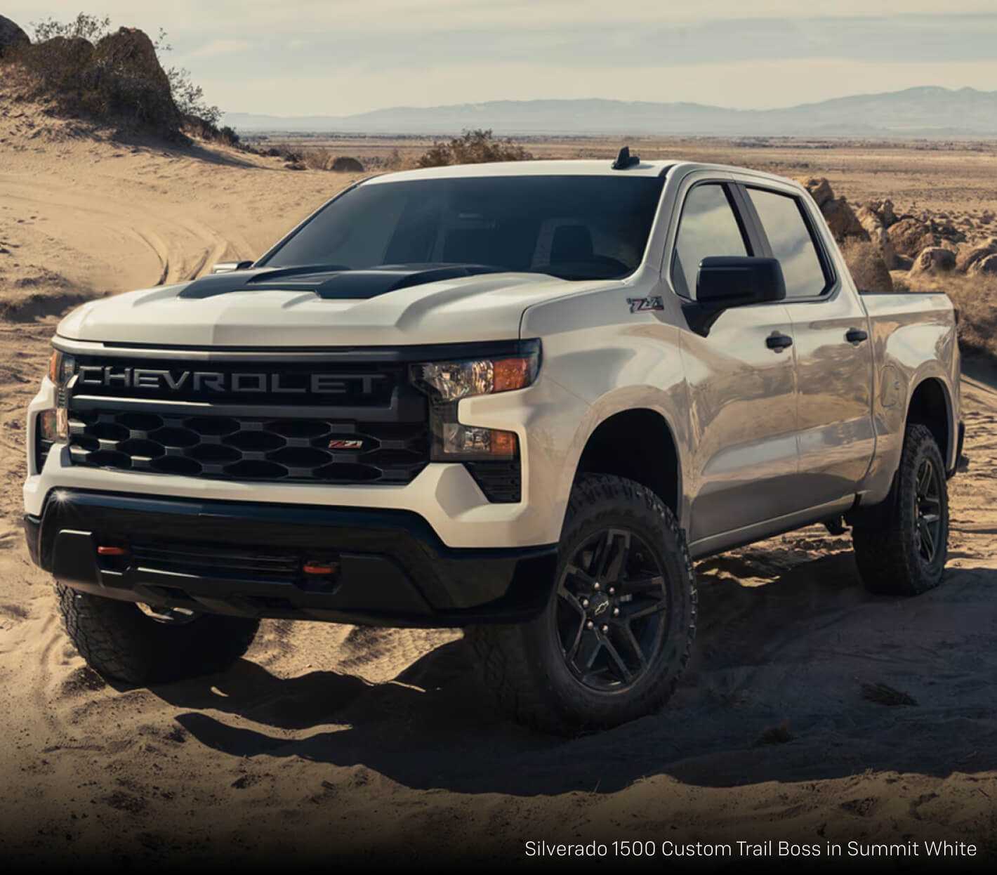 Chevrolet Silverado 1500 Custom Trail Boss in Summit White on sandy and rocky terrain