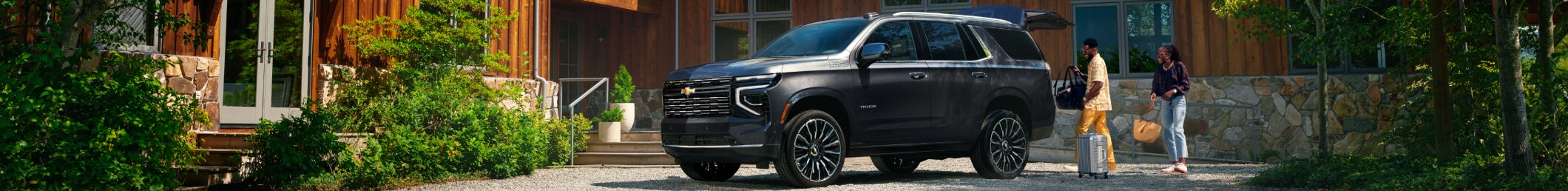 Black Chevrolet SUV parked in residential driveway