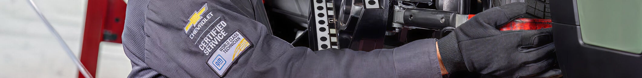 Certified technician working on vehicle undercarriage