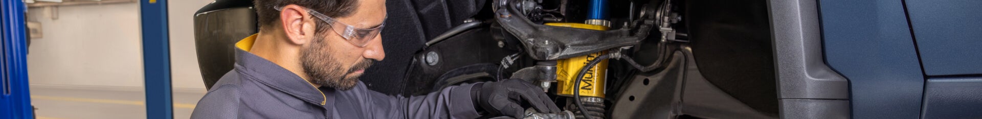 Chevrolet service worker, working on the brake system