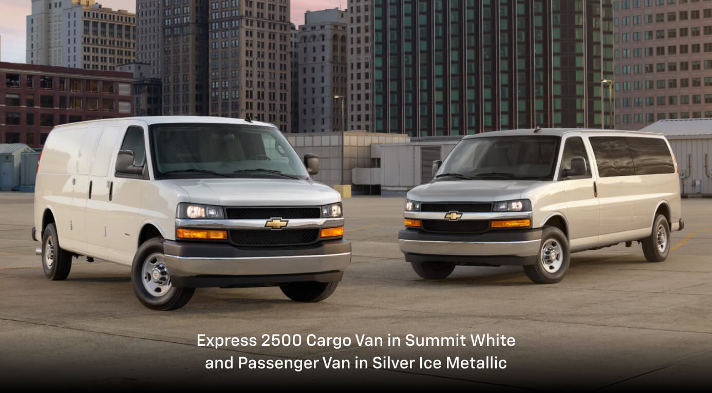 2026 Chevrolet Express 2500 Cargo Van in Summit White and Passenger Van in Silver Ice Metallic, parked with buildings behind.